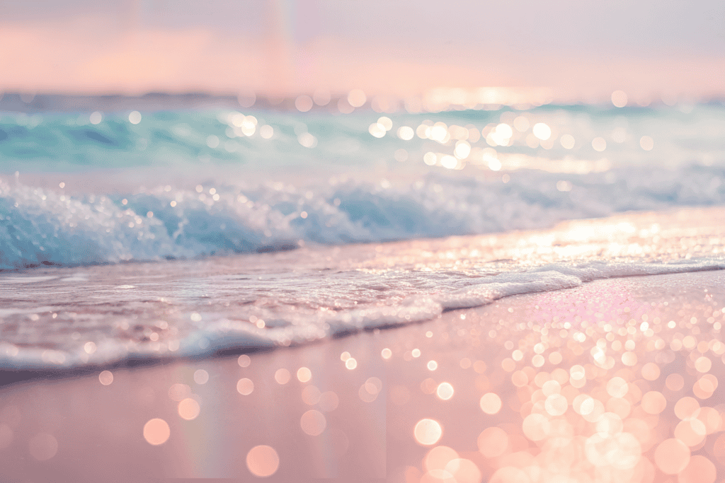 A dreamy pastel beach scene with gentle waves and sparkling pink and teal light